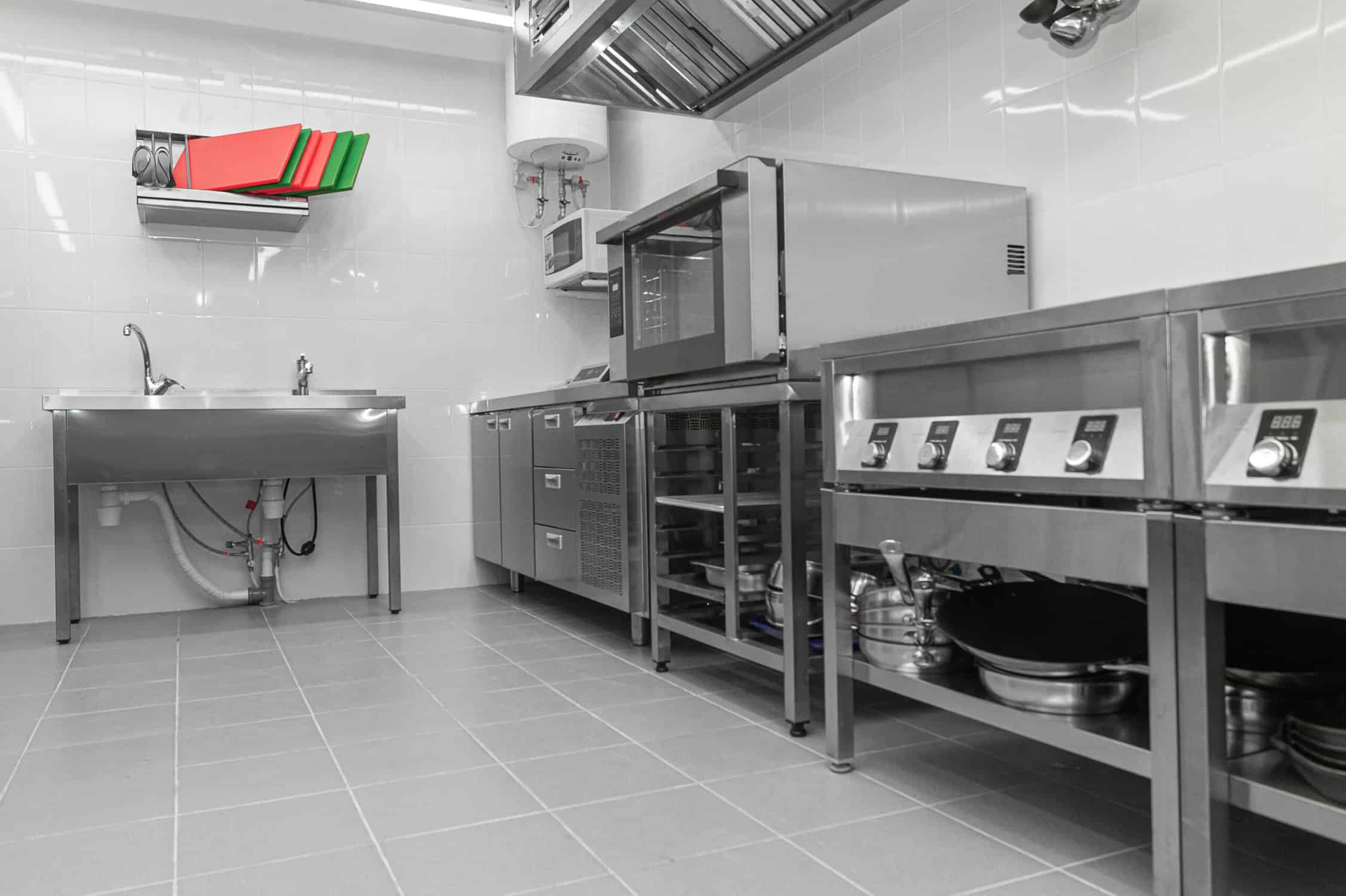 Design of the working area of the commercial cafe kitchen with stainless steel equipments, hot shop, food industry.